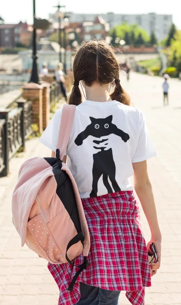 model wearing white t-shirt with black cat design